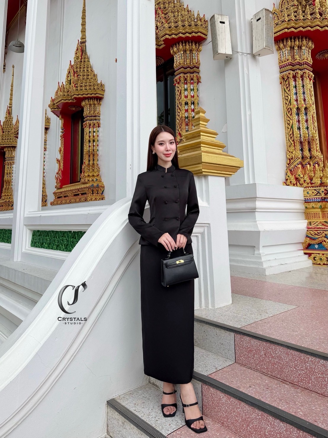 งานชุดไทยสีดำจิตรลดา เนื้อผ้าซาติน ดีไซน์กระดุมคู่ ช่วงคอดีไซน์ทรงคอจีนเสริมความสง่า ทรงสุภาพ มาพร้อมกับกระโปรงผ้าหลัง เสริมความคล่องตัวในการเดิน เหมาะสำหรับใส่ร่วมงานพิธีทางการ