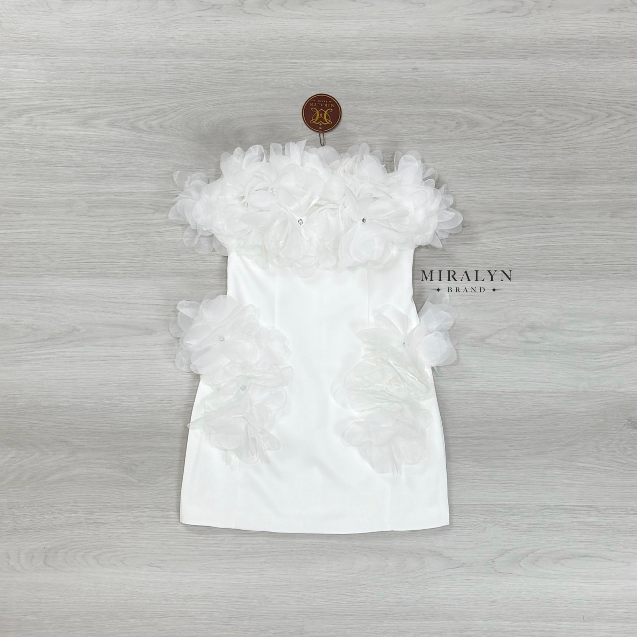 เดรสเกาะอกสีขาวทรงเข้ารูป แต่ง detail ด้วยดอกไม้ช่วงอกแน่นๆและเย็บด้วยเพชรเป็นเกสรและแต่งดอกไม้ที่ช่วงสะโพกทั้งสองข้างอกมีฟองน้ำเสริมและมีซับทั้งตัว #Miralynstudio#Miralynbrand#miralynชุดออกงาน#เดรสออกงาน#ชุดดินเนอร์