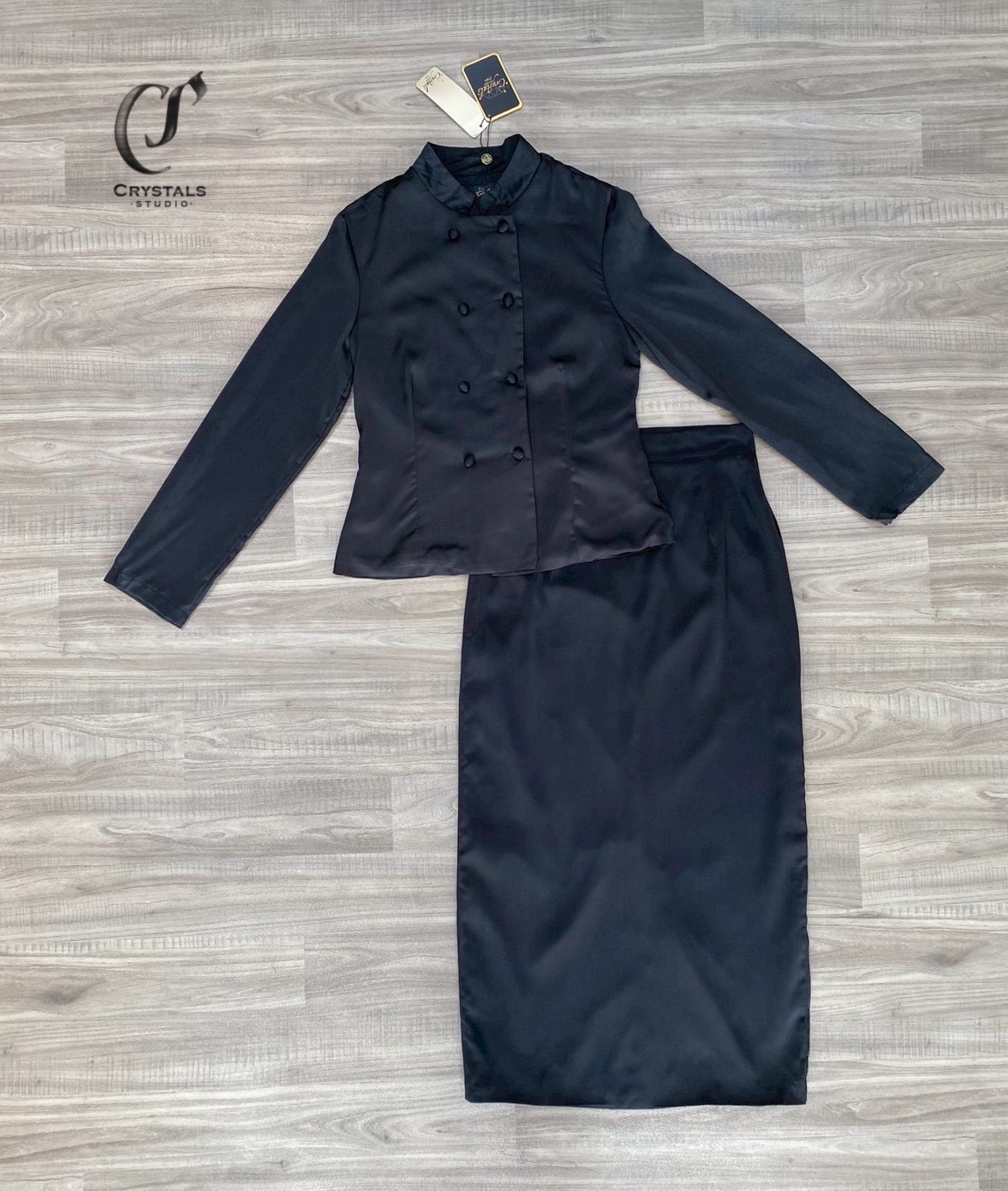 งานชุดไทยสีดำจิตรลดา เนื้อผ้าซาติน ดีไซน์กระดุมคู่ ช่วงคอดีไซน์ทรงคอจีนเสริมความสง่า ทรงสุภาพ มาพร้อมกับกระโปรงผ้าหลัง เสริมความคล่องตัวในการเดิน เหมาะสำหรับใส่ร่วมงานพิธีทางการ